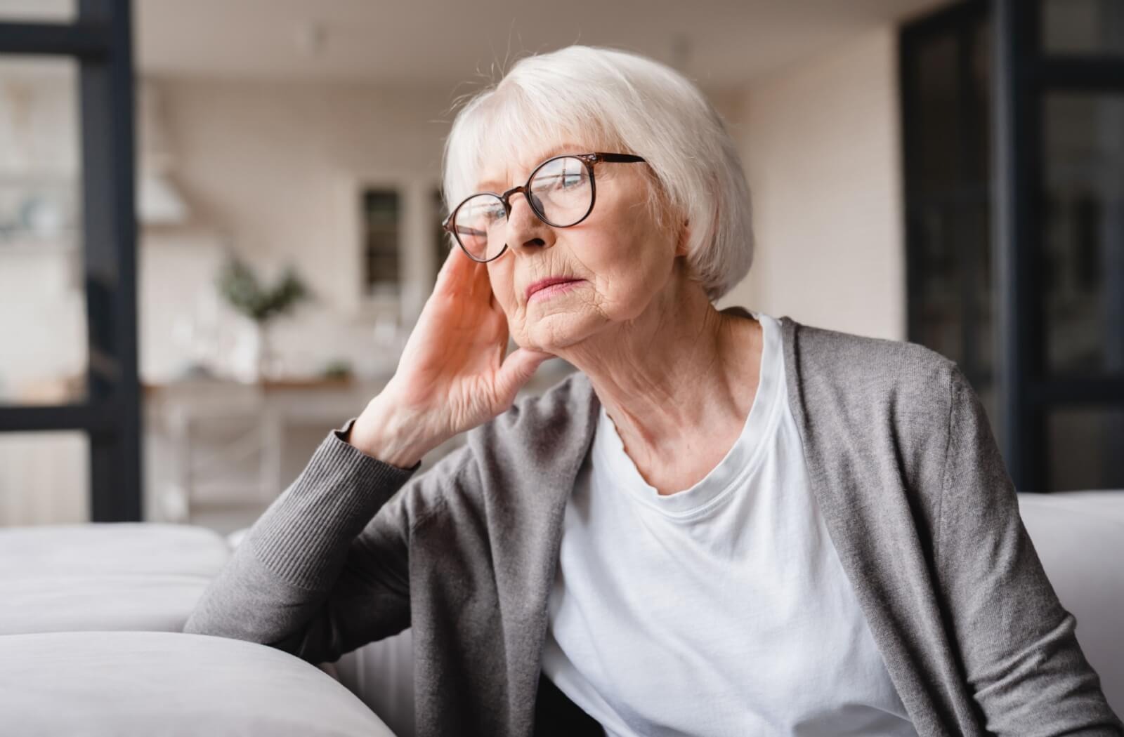 a senior looks out a window